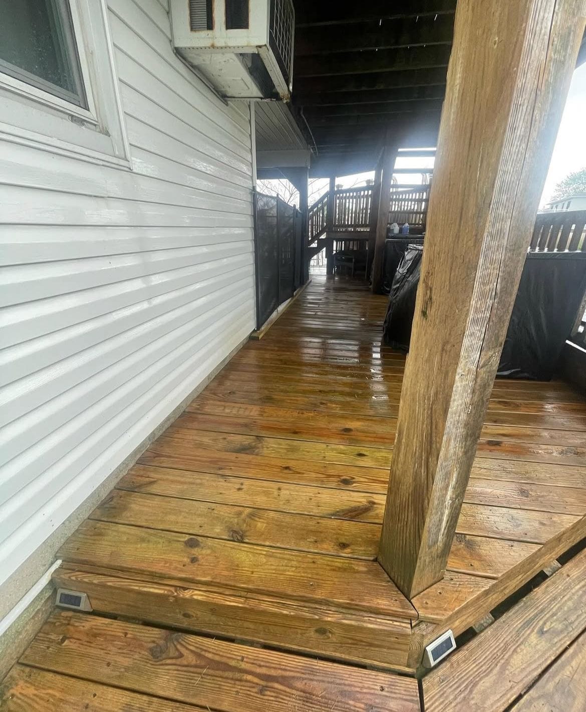 Pressure washing professionals in Long Island Soft washing siding and roofing Experienced handyman on residential job Before and after pressure washing deck Gutter cleaning and roof soft washing Handyman deck repair in progress Exterior house washing project Long Island pressure washing team at work