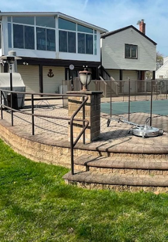 Pressure washing professionals in Long Island Soft washing siding and roofing Experienced handyman on residential job Before and after pressure washing deck Gutter cleaning and roof soft washing Handyman deck repair in progress Exterior house washing project Long Island pressure washing team at work